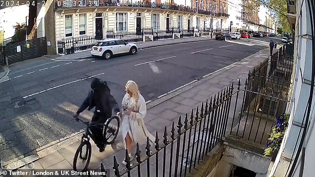 This terrifying phone snatch in Marylebone, central London, shows a thief taking a woman's phone as he zooms past on an e-bike