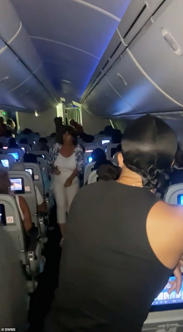 Video footage has shown the scene of chaos onboard the flight, as disorientated passengers anxiously stood in the aisles. One member of cabin crew onboard the flight is heard attempting to reassure passengers, stating: 'Please return to your seats'