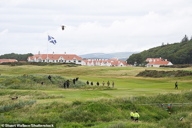 Police officers and soldiers sweep the golf course with search poles this morning