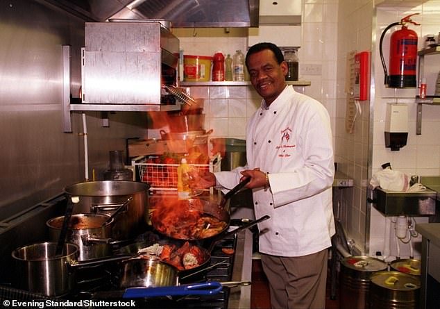 Pictured: Roger cooking seafood in the restaurant, where he once worked, after buying it with his lottery winnings