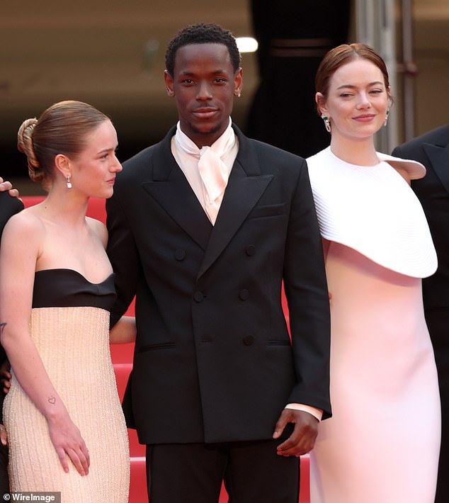 Amelie Hoeferle, Micheal Ward and Emma Stone attend the 'Eddington' red carpet at the 78th annual Cannes Film Festival at Palais des Festivals on May 16, 2025