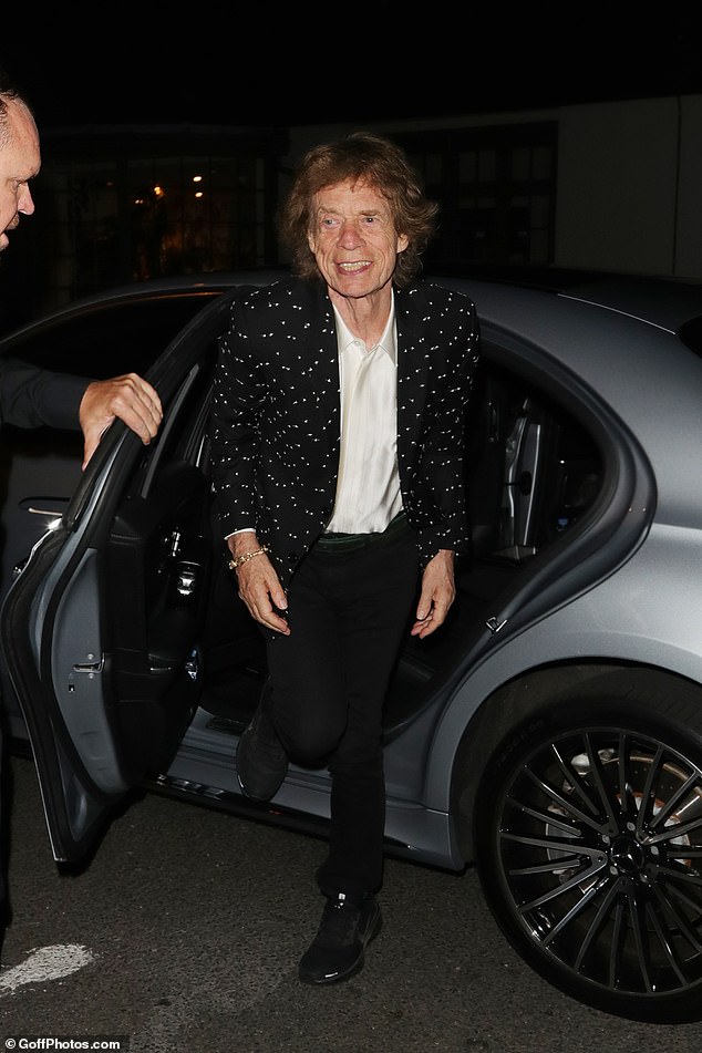 For his A-list bash, Mick cut a dapper figure in a white silk shirt and black trousers, which he styled with a spotted black jacket