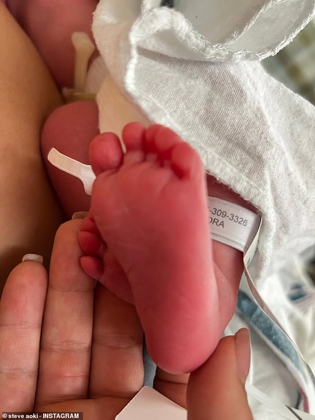 Sharing the first snap of his newborn, the American DJ announced the happy news to his 11.6million fans as he revealed the newborn's arrival was a 'surprise'