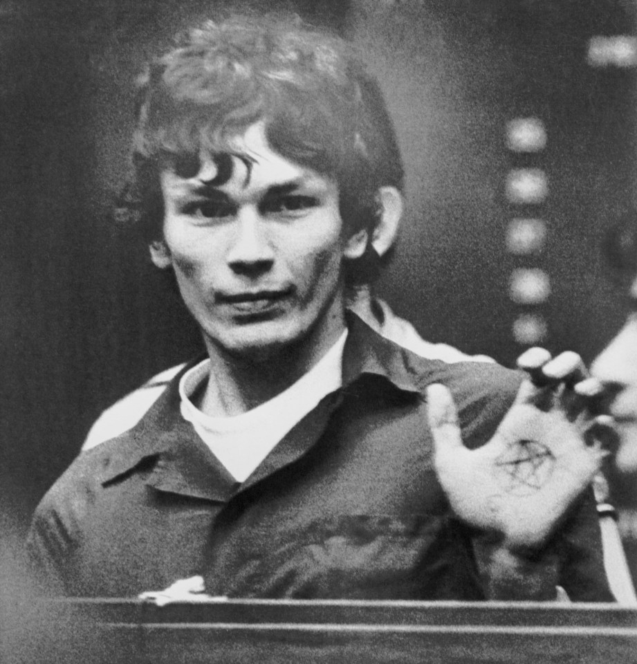 Richard Ramirez, the "Night Stalker," showing a pentagram on his hand at a hearing.