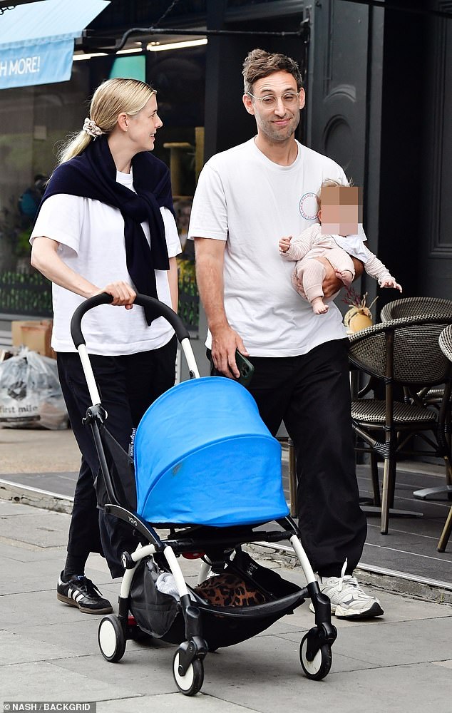 Agyness pushed the pram along, while Joel carried the baby inside the restaurant at Primrose Hill