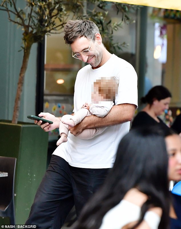 Joel also opted for a white T-shirt and black trousers