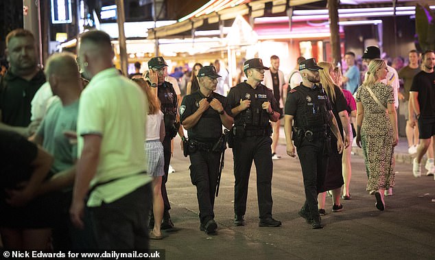 Police officers, some carrying headgear, were patrolling the S'Arenal area through the night when MailOnline visited the resort this week