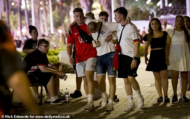 A 5km stretch along S'Arenal is now considered a German hotspot and is often compared to Brits' go-to nightlife spot Magaluf. Pictured: A man being carried by friends after a night out. Many Germans were seen donning football shirts and armbands in the colours of the German flag