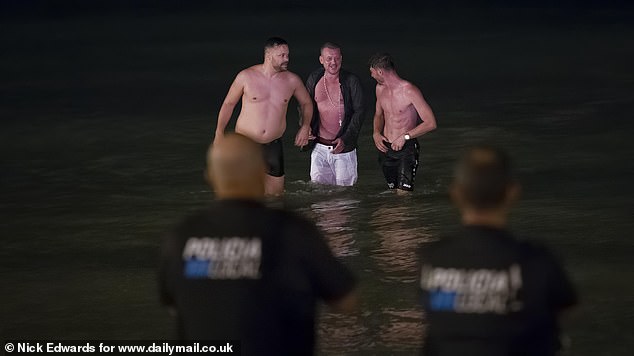 Drunk Germans are said to be cause of frustration among locals. Here three men can be seen walking out of the sea at 1am after being spotted by police