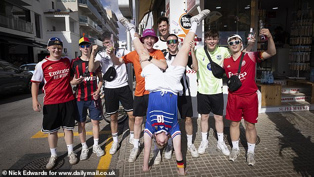 Lads holiday: Sporting football shirts, German armbands and hats, this group of friends posed while out partying in 'German Magaluf'. By early evening large groups were seen chugging down beer bottles