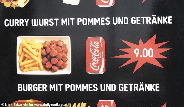 A board displaying Currywurst with chips for nine euros. The sign was written in Deutsch