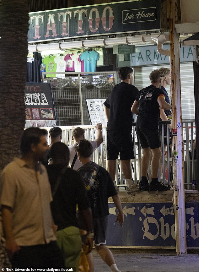 Drunk men sporting German armbands were seen jumping over the fencing of a storefront to get to a tattoo parlour. The noisy group then began singing