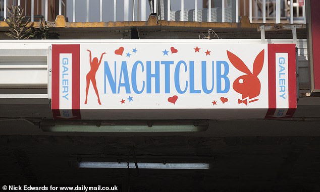 Another 'Nachtclub' sign, which translates to nightclub. Next door is a tattoo parlour and above it a pharmacy