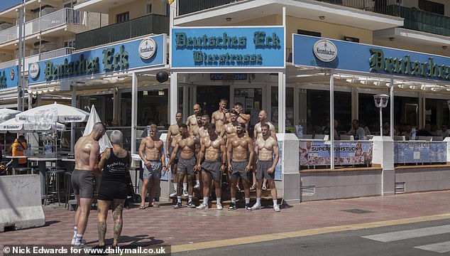 When MailOnline took a stroll around S'Arenal on Tuesday morning a group of shirtless men were seen posing for a picture in front of a German eatery