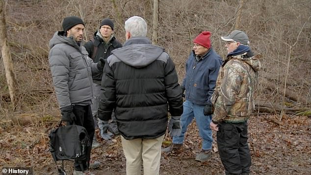 Pictured: The History Channel team, alongside first-hand UFO witnesses Bill Weaver (second from right) and Ronnie Strubel (right), stand in the woods near the supposed crash site