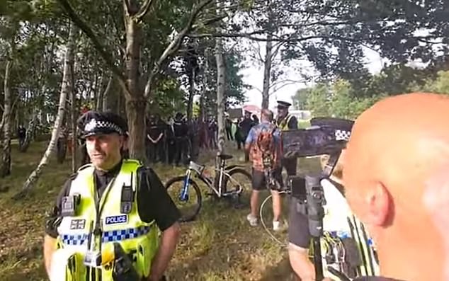 Officers formed a defensive cordon around the building, which was targeted during last summer's riots
