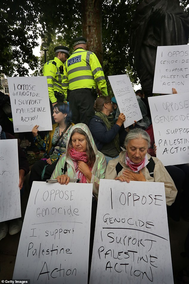 Rallies were also held in Edinburgh and Truro last week to protest the proscription of the campaign group as a terrorist organisation earlier this month. Pictured: Protesters hold up signs in support of Palestine Action at the demonstration in London