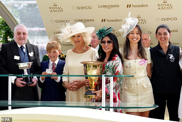 Owner Fitri Hay (centre right) is presented the trophy by Queen Camilla after seeing horse Khaadem win the Queen Elizabeth II Jubilee Stakes during day five of Royal Ascot