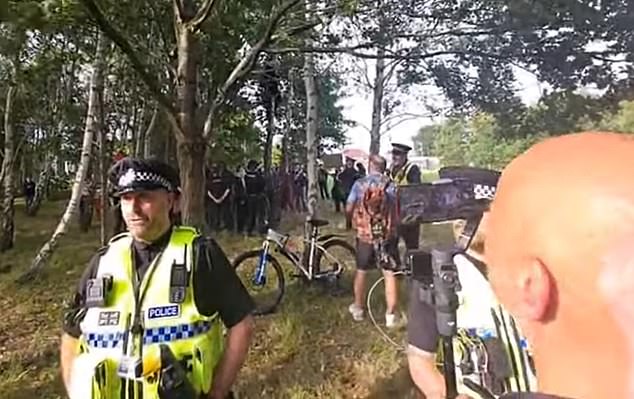 Officers formed a defensive cordon around the building, which was targeted during last summer's riots