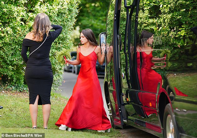 A bridesmaid of Eve Jobs steps out of the coach as they arrive for the lavish wedding ceremony this evening