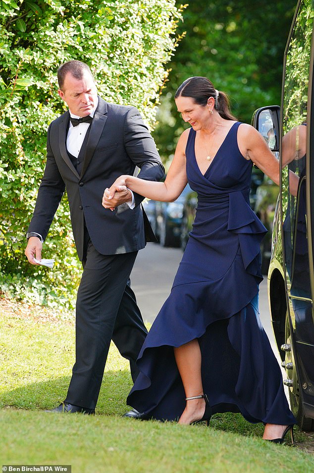 Another guess wore a dark blue dress, while the accompanying gentleman wore a black suit