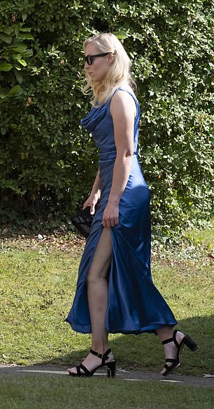 Another pictured wearing a dark blue dress topped off with black heels and a matching handbag