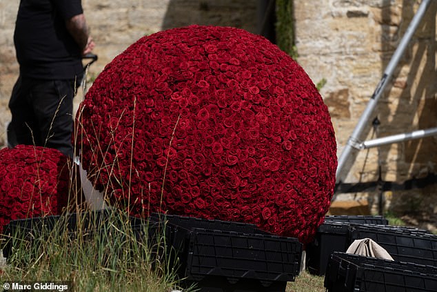 Outside the church, thousands of red roses were placed into 5ft-tall balls dotted around the yard