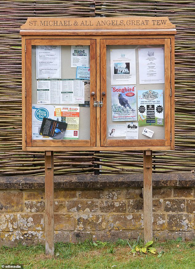 A sign with posters outside St Michael & All Angels Church in Great Tew, Oxfordshire