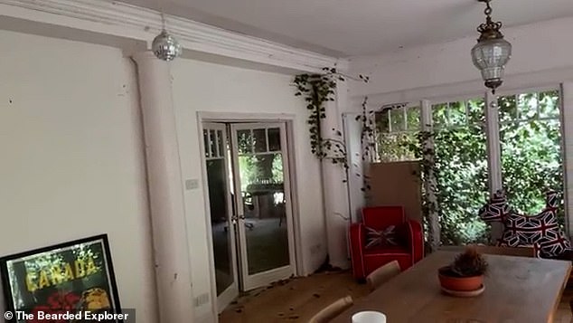 Urban explorers filmed inside the abandoned property where vines had started snaking up the walls (pictured)
