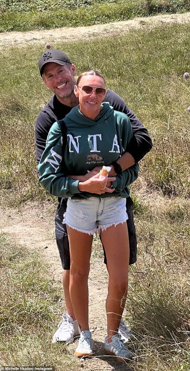 She credits clean living and regular workouts for her transformation (pictured with her husband Hugh who shehas been with for 17 years)
