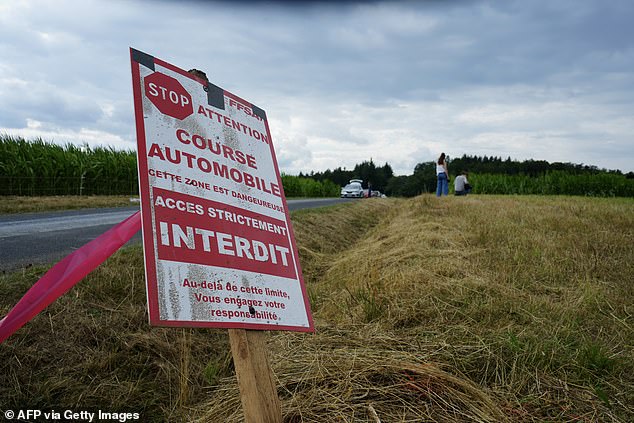 A warning sign at the edge of the race route highlights the dangers of the event. Three people were killed in Saturday's crash, including two brothers