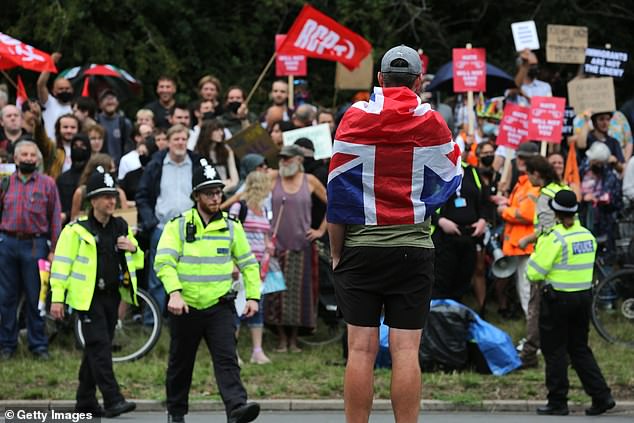 Police officers separated the main group from a set of counter protesters, some of whom were waving Revolutionary Communist Party flags