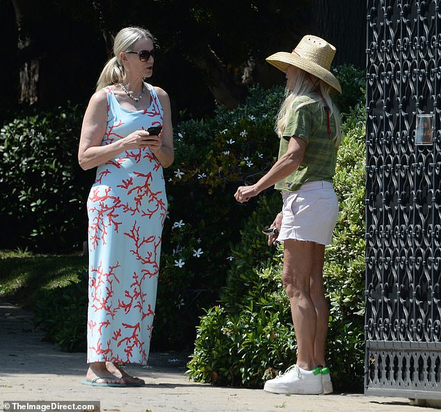 The former actress was joined by a friend in a breezy blue-and-red coral-patterned dress as the pair chatted