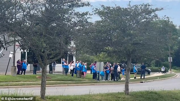 Police were seen interviewing workers from the supermarket across the street following the incident. Many were seen still wearing their Walmart overalls