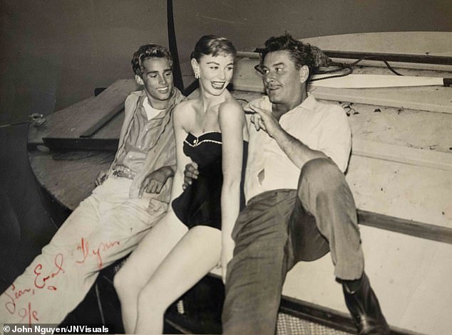 Teresa aged 19 with actor Errol Flynn (right) and his son Sean (left)
