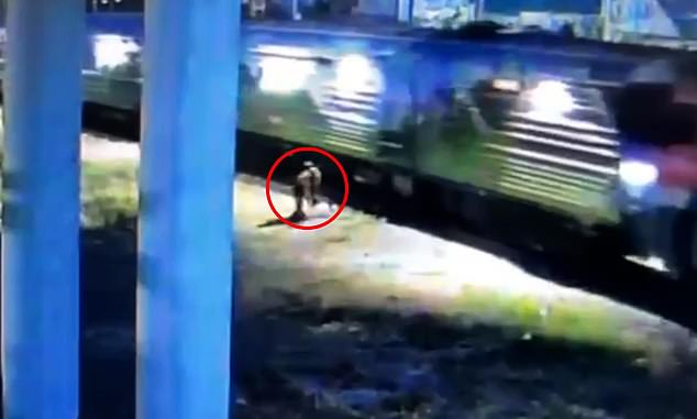 Sprinting over the track as the train hurtled towards him, the courageous pedestrian saved the man's life by pulling his body to safety