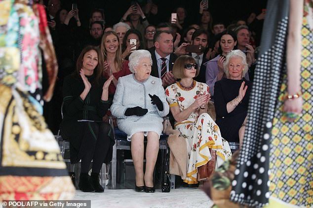 Queen Elizabeth II views British designer Richard Quinn's runway show before presenting him with the inaugural Queen Elizabeth II Award for British Design, during her visit to London Fashion Week's BFC Show Space in central London on February 20, 2018