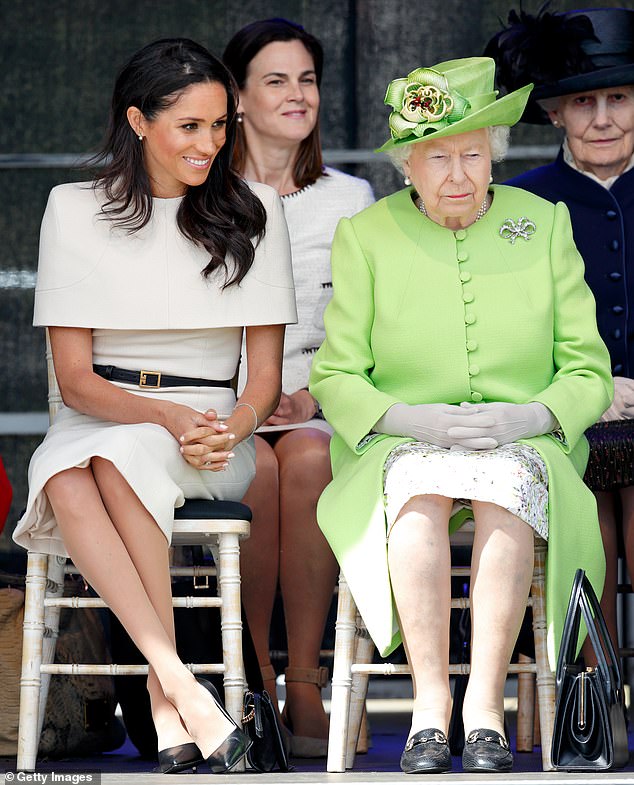 Meghan and the late Queen Elizabeth with royal aide Ms Cohen sat behind them (centre)