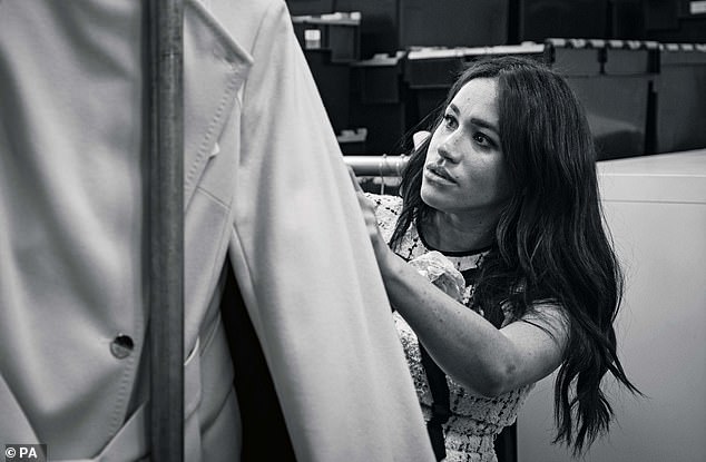 A candid photograph released alongside the September cover pictures the Duchess in the workroom of the Smart Works office in London