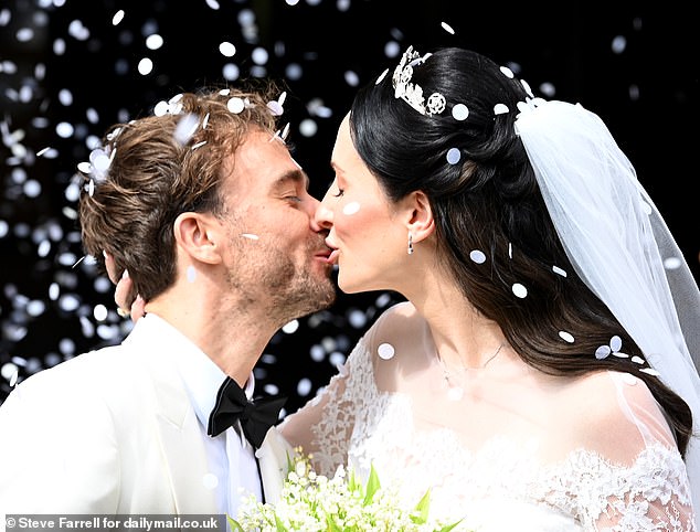 The bride and groom shared their first kiss as a married couple