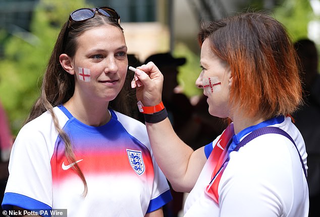 England fans put face paint on ahead of the UEFA Women's Euro 2025 final at St. Jakob-Park in Basel, Switzerland