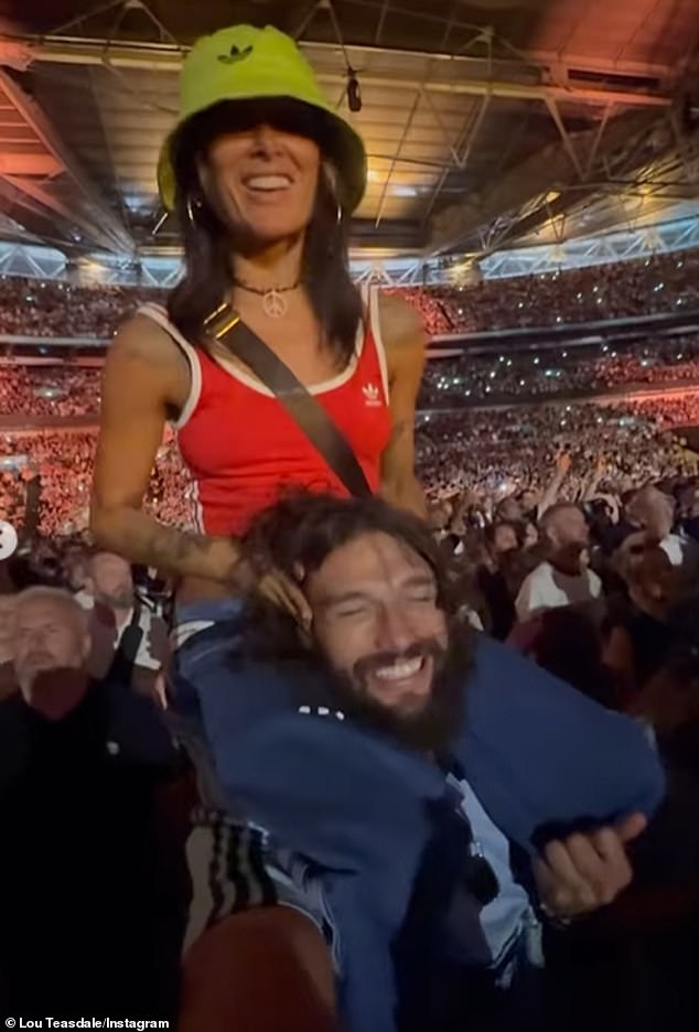 In other snaps, the mother-of-one danced on the athletes shoulders to the bands hit songs Roll With It and Wonderwall