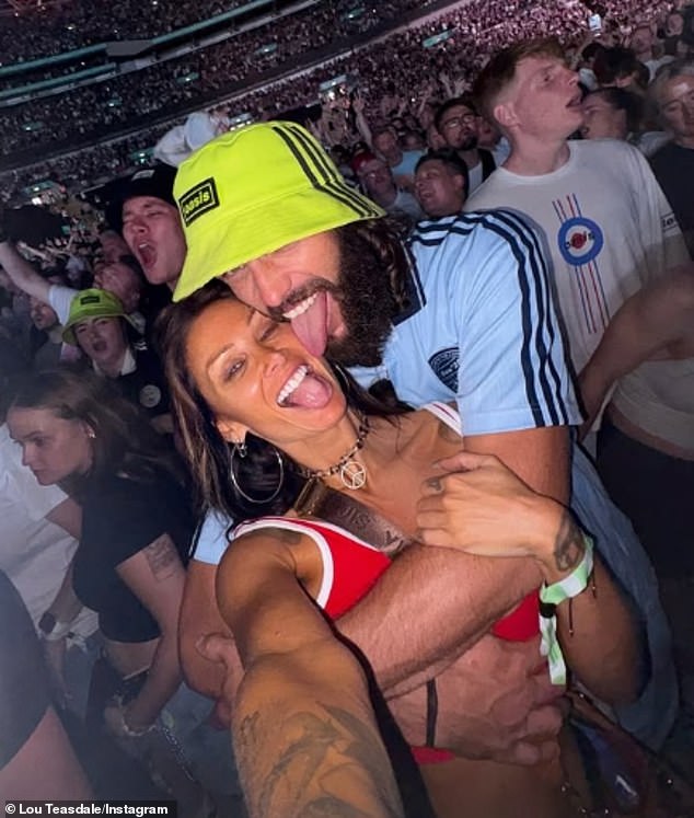 The couple were seen kissing and licking each others faces as they posed for selfies in the crowd