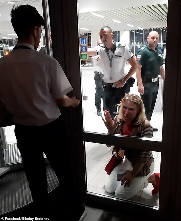 Shocked passengers waiting to board a bus to the aircraft watched on as the tearful woman hit the doors separating her and the other passengers in despair