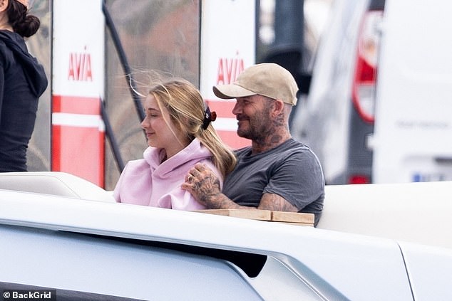 Every the doting dad, David embraced his daughter Harper, 14, as they boarded a speedboat to take them to the shore
