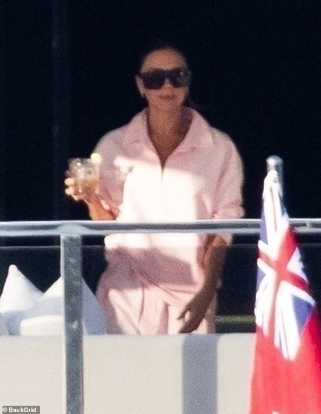 Victoria showed off her laid-back sense of style in a pale pink co-ord as she relaxed on the yacht with an ice cold beverage