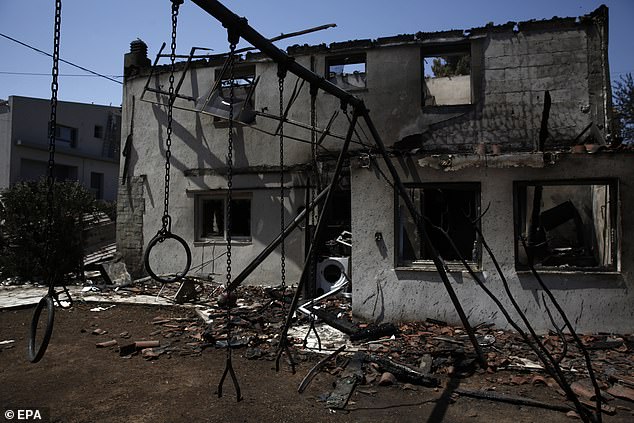 A burned house after a wildfire in the area of Kryoneri, in the suburbs of Athens, Greece