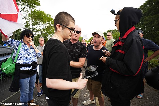 A protester shouts at a man filming footage of the protest in Epping, Essex, on Sunday