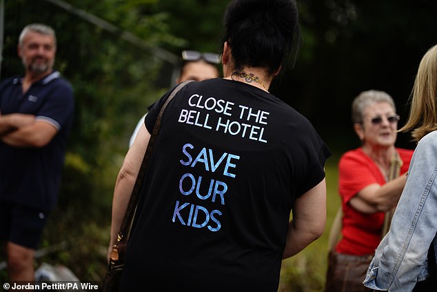 A protester calls for The Bell Hotel to be closed down, saying: 'Save our kids'