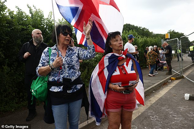 Protesters carrying Union Flags gather near the Bell Hotel on Sunday